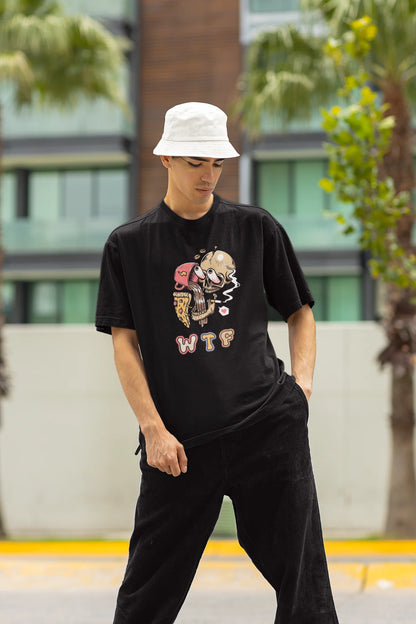 Front view of a male model wearing an black oversized t-shirt featuring a skull enjoying coffee, pizza, and smoking, offering a unique and edgy aesthetic.