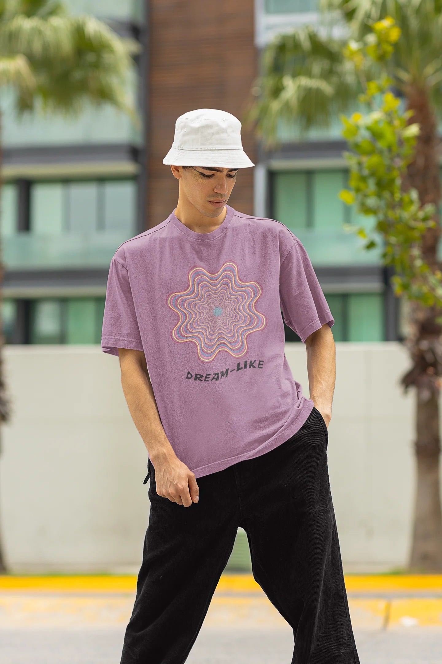Front view of a male model wearing an dirty purple oversized t-shirt with a dreamlike spiderweb design made of frequencies, offering a visually captivating and relaxing aesthetic.