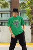 Front view of a male model wearing a forest green oversized t-shirt featuring a psychedelic magic mushroom with an aura, perfect for a hippie, trance, or groovy style.