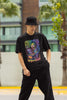 Front view of a male model wearing an black oversized t-shirt featuring a psychedelic melting green zombie design, perfect for a trippy, dark aesthetic.