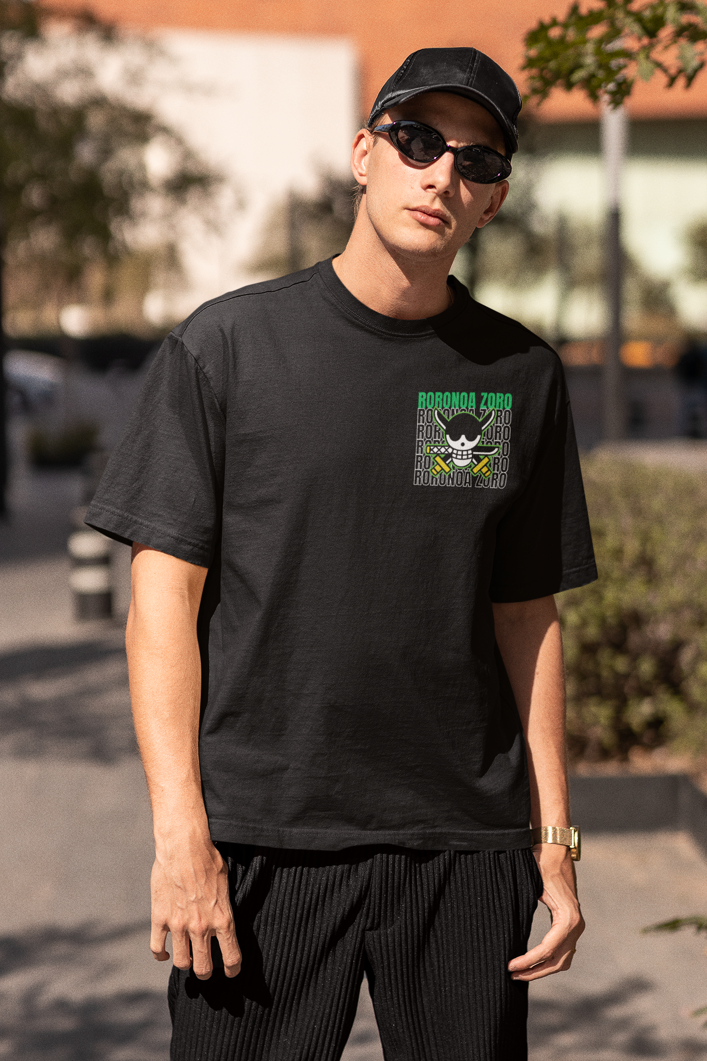 3rd front view of a male model wearing a black oversized t-shirt featuring Roronoa Zoro from the One Piece anime.