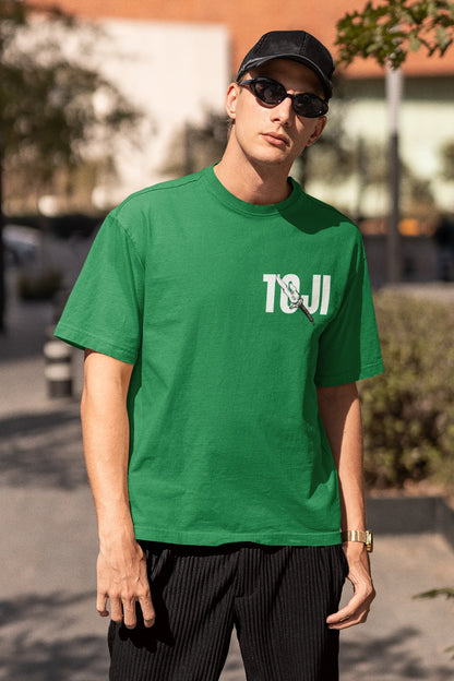 2nd front view of a male model wearing a forest green oversized t-shirt featuring Toji Fushiguro from the Jujutsu Kaisen anime.