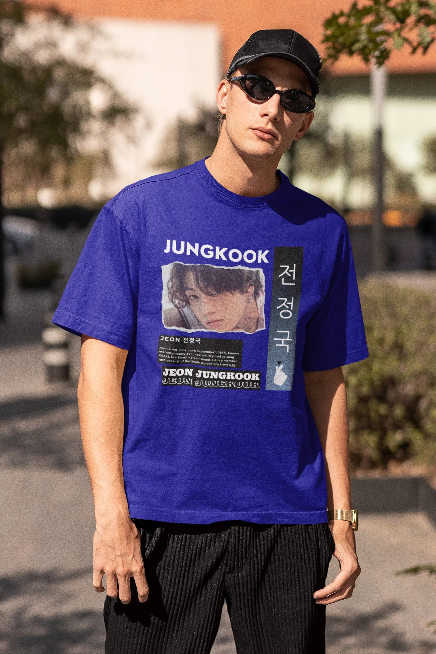 Third front view of a male model wearing a royal blue oversized t-shirt featuring a vibrant design inspired by BTS member Jungkook. Ideal for fans of BTS and K-Pop music in general.