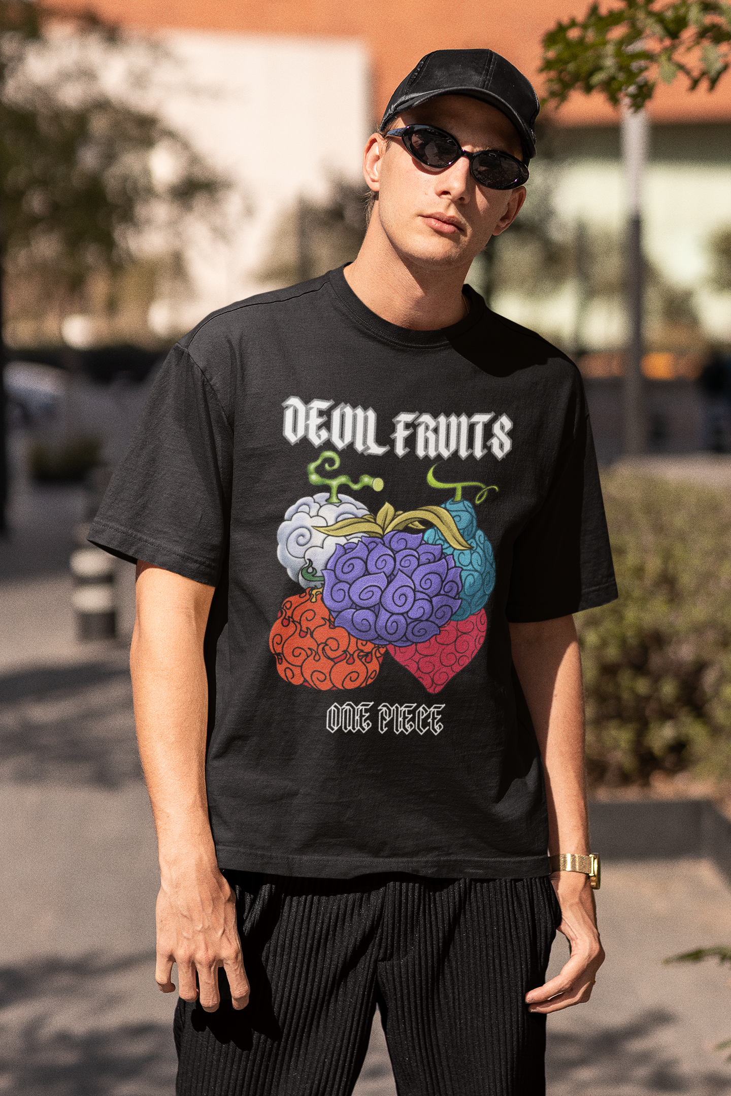 3rd front view of a male model wearing a black oversized t-shirt featuring a design of a Devil Fruit from the One Piece anime.