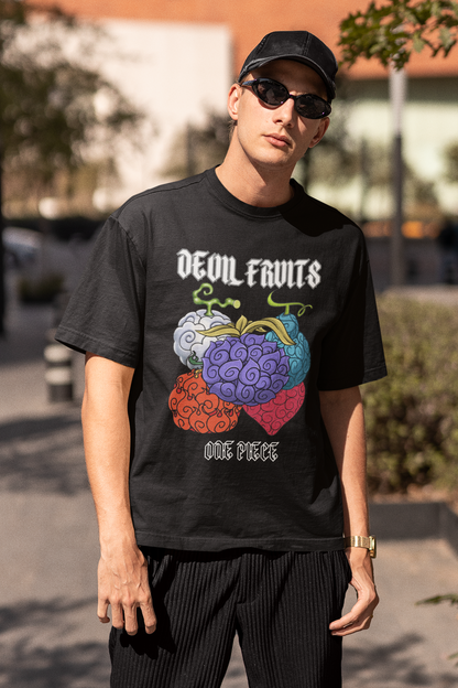 3rd front view of a male model wearing a black oversized t-shirt featuring a design of a Devil Fruit from the One Piece anime.