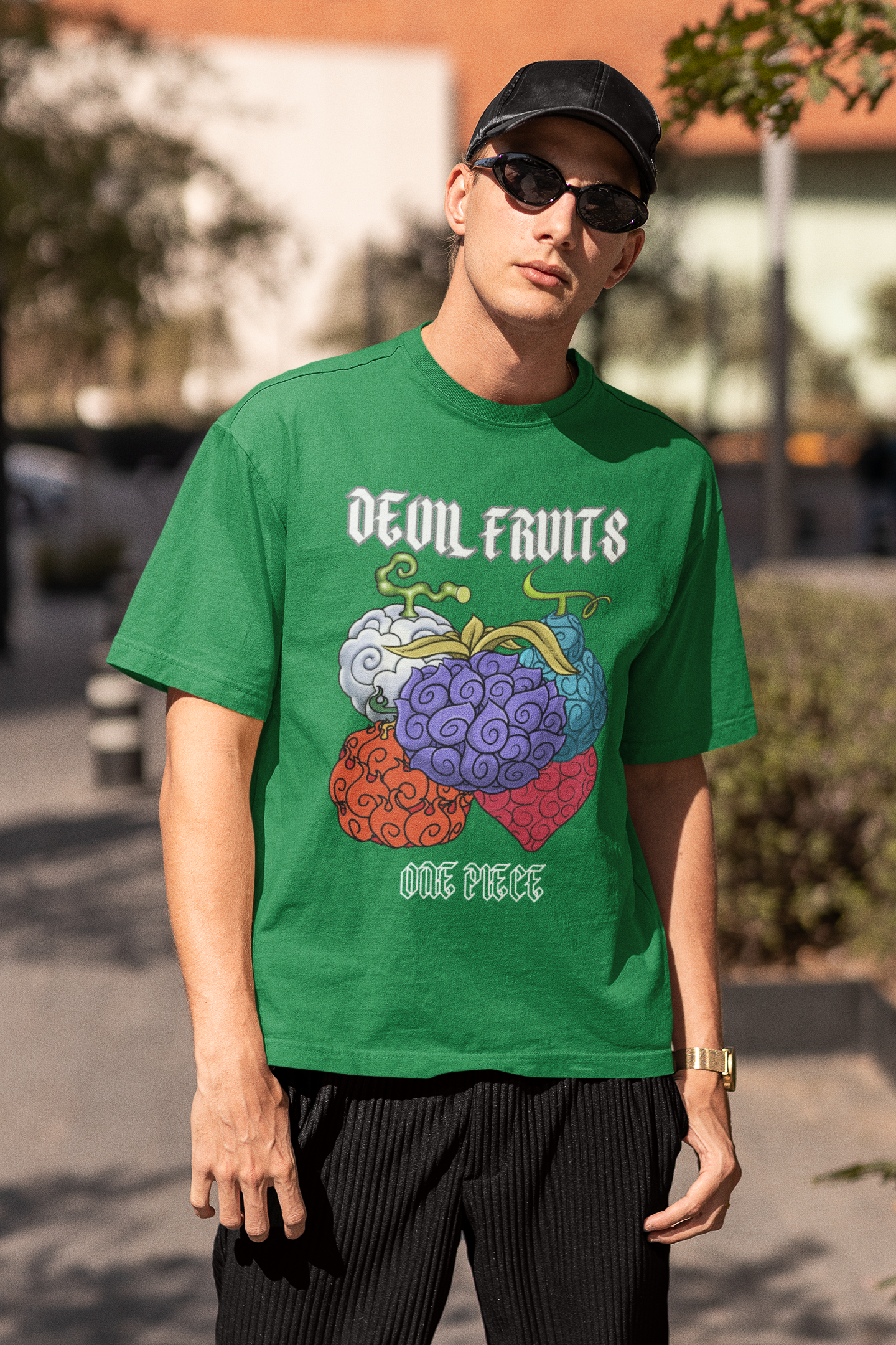 2nd front view of a male model wearing a forest green oversized t-shirt featuring a design of a Devil Fruit from the One Piece anime.