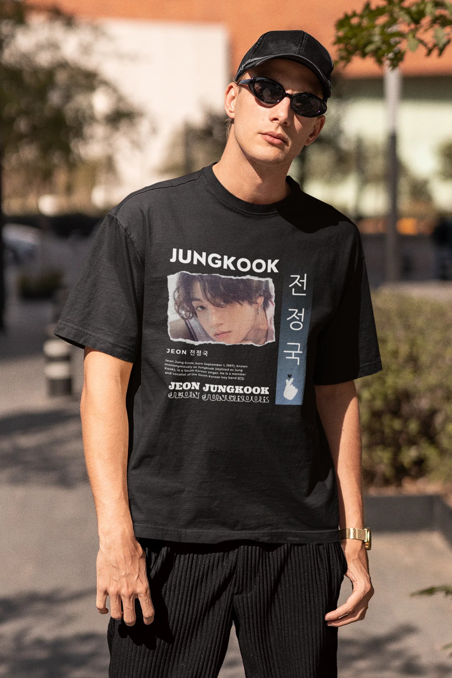 Third front view of a male model wearing a black oversized t-shirt featuring a vibrant design inspired by BTS member Jungkook. Ideal for fans of BTS and K-Pop music in general.