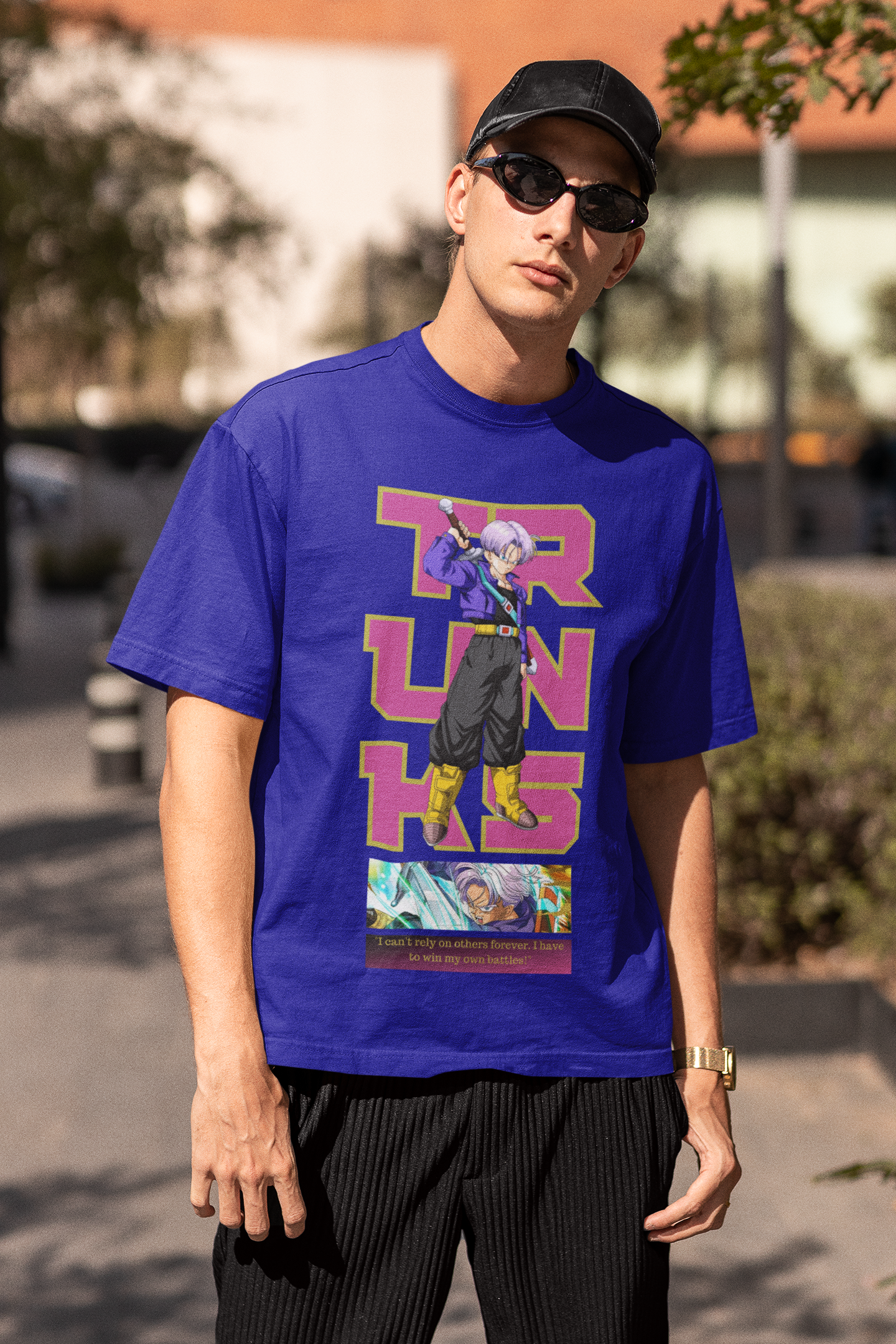 3rd front view of a male model wearing a royal blue oversized t-shirt featuring Trunks from Dragon Ball Z with the text "Trunks."