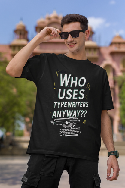 First Image of man wearing black Oversize t-shirt featuring TTPD design inspired by Taylor Swift's Eras Tour.