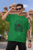 First front view of a male model wearing an forest green oversized t-shirt featuring an aesthetic design of a setting sun and crashing waves with the text 