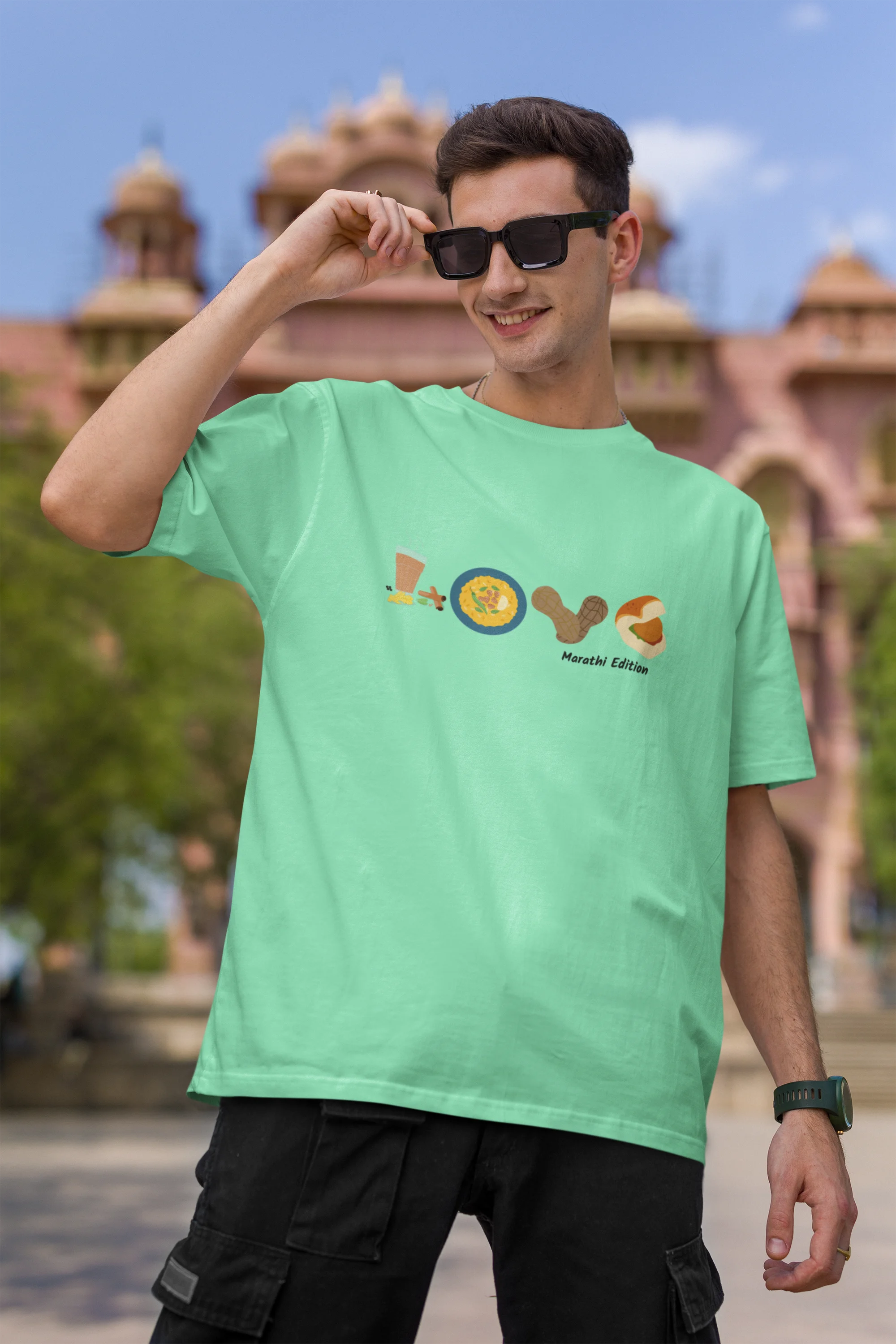 First front view of a male model wearing an mint green oversized t-shirt with a colorful design that celebrates Marathi culture. Ideal for anyone who loves Maharashtra and its vibrant heritage.