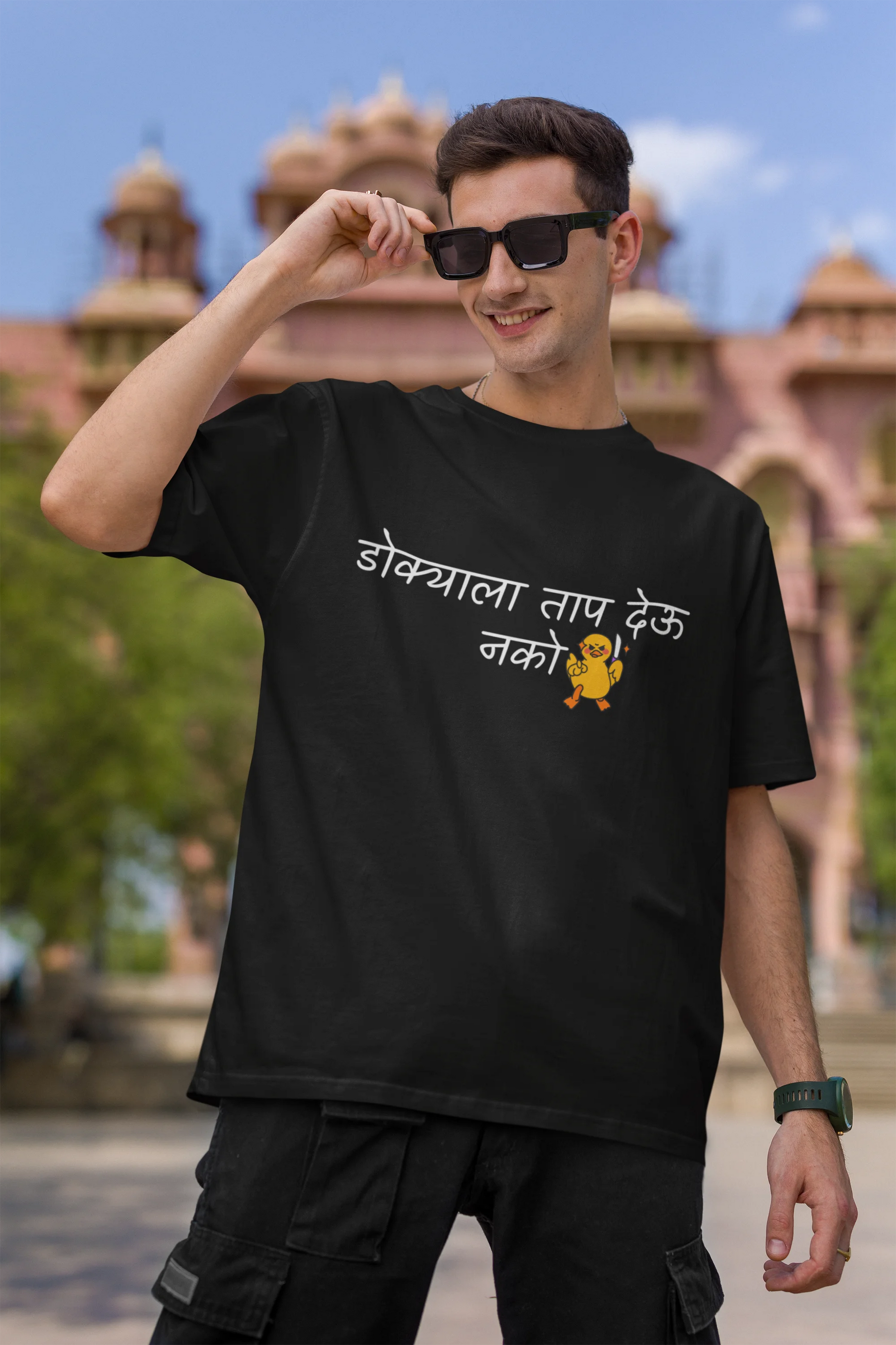 First front view of a male model wearing a black oversized t-shirt featuring a design inspired by Marathi culture. Perfect for anyone who loves Maharashtra and its vibrant traditions.