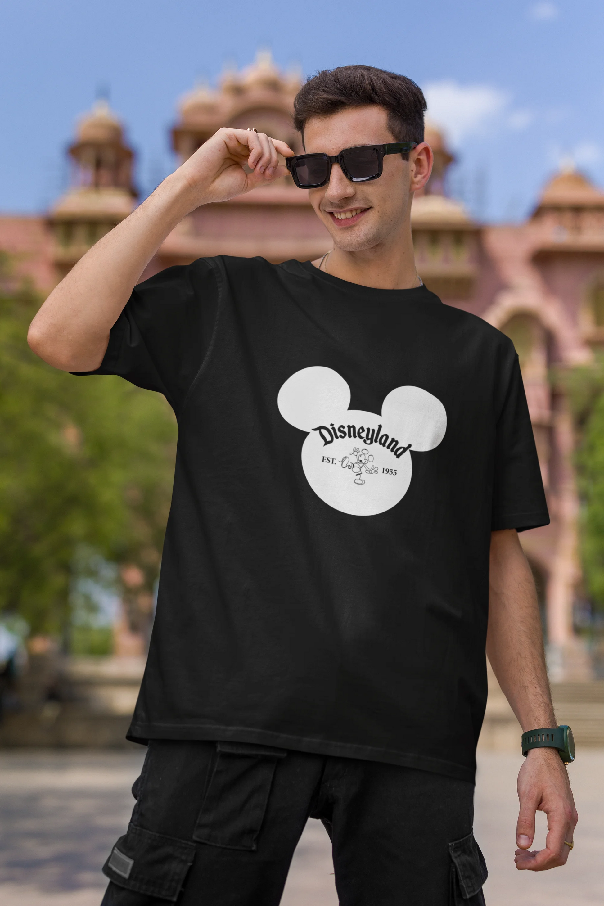 First image of male model wearing a black oversized Disney collection t-shirt featuring a classic Disneyland design.