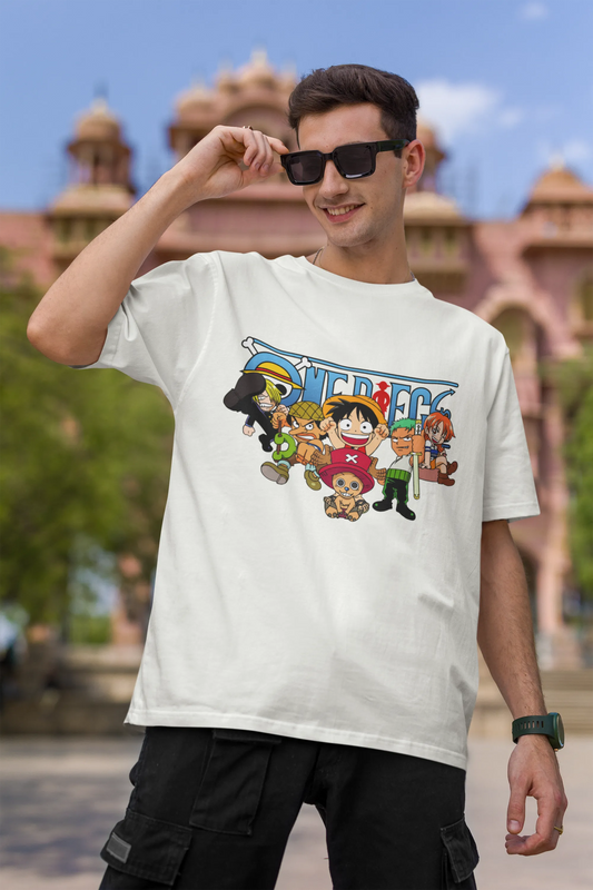First front view of a male model wearing an off-white oversized t-shirt featuring chibi versions of the Straw Hat Crew from the One Piece anime.