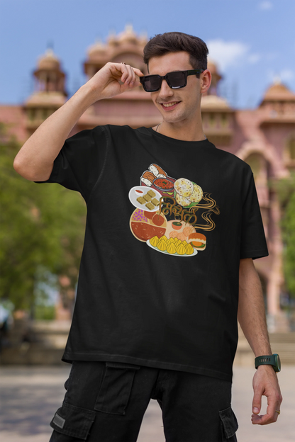First front view of male model wearing an black oversized t-shirt featuring a design inspired by the Marathi dish Misal Pav. Ideal for fans of Marathi culture, foodies, and anyone who loves a flavorful meal.