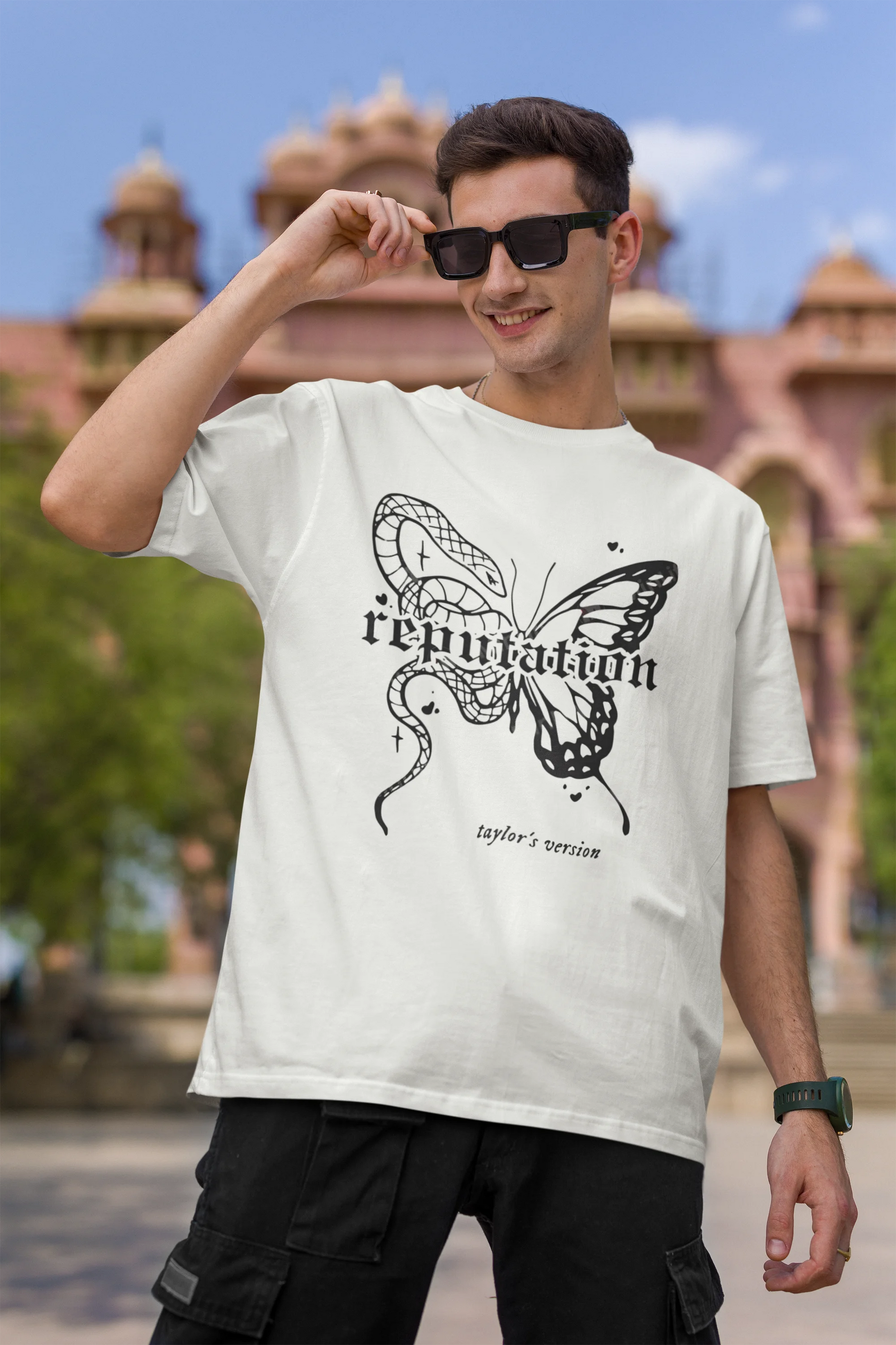 First Image of a man wearing white Oversize t-shirt featuring Reputation Taylor's Version design inspired by Taylor Swift's Reputation era
