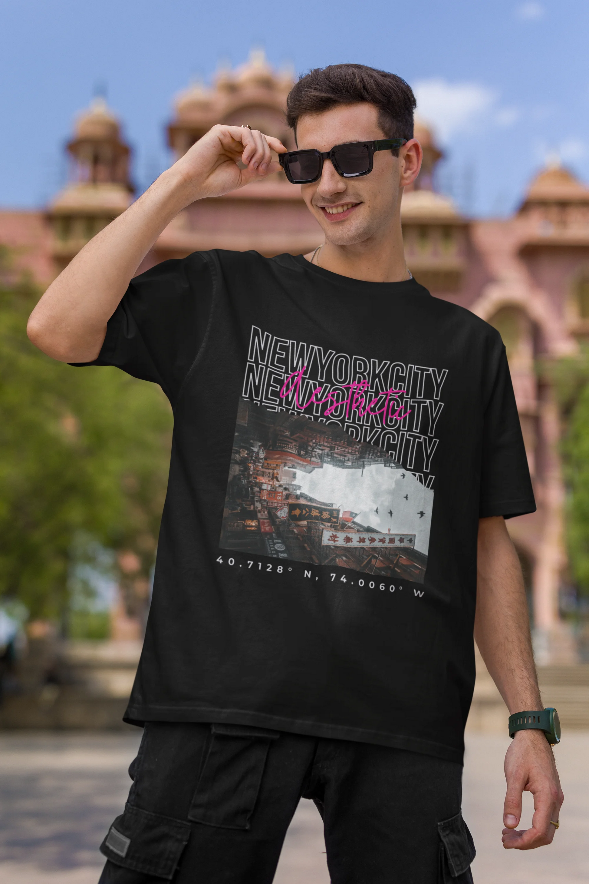 First front view of a male model wearing a black oversized t-shirt with a New York City skyline design, offering a relaxed urban aesthetic.