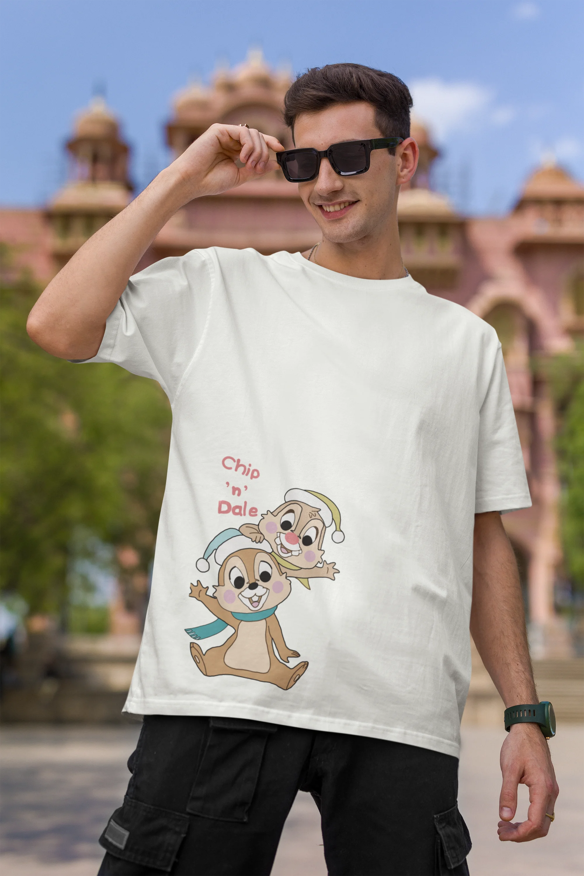 First image of male model wearing off-white oversized tee with a Disney's Chip and Dale design, featuring the adorable duo in a playful scene.