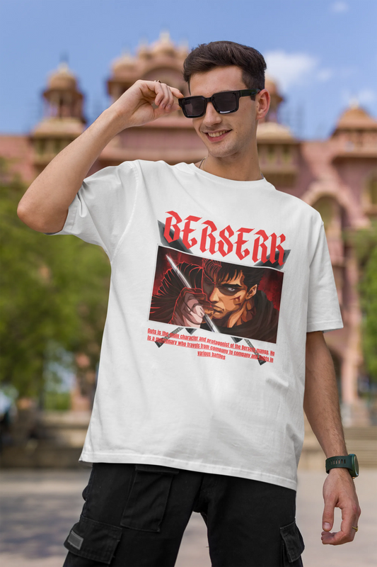 First front view of a male model wearing an off-white oversized t-shirt featuring Guts from the Berserk anime with the text "Berserk" across the design.
