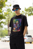 Right side view of a male model wearing an black oversized t-shirt featuring a psychedelic melting green zombie design, perfect for a trippy, dark aesthetic.