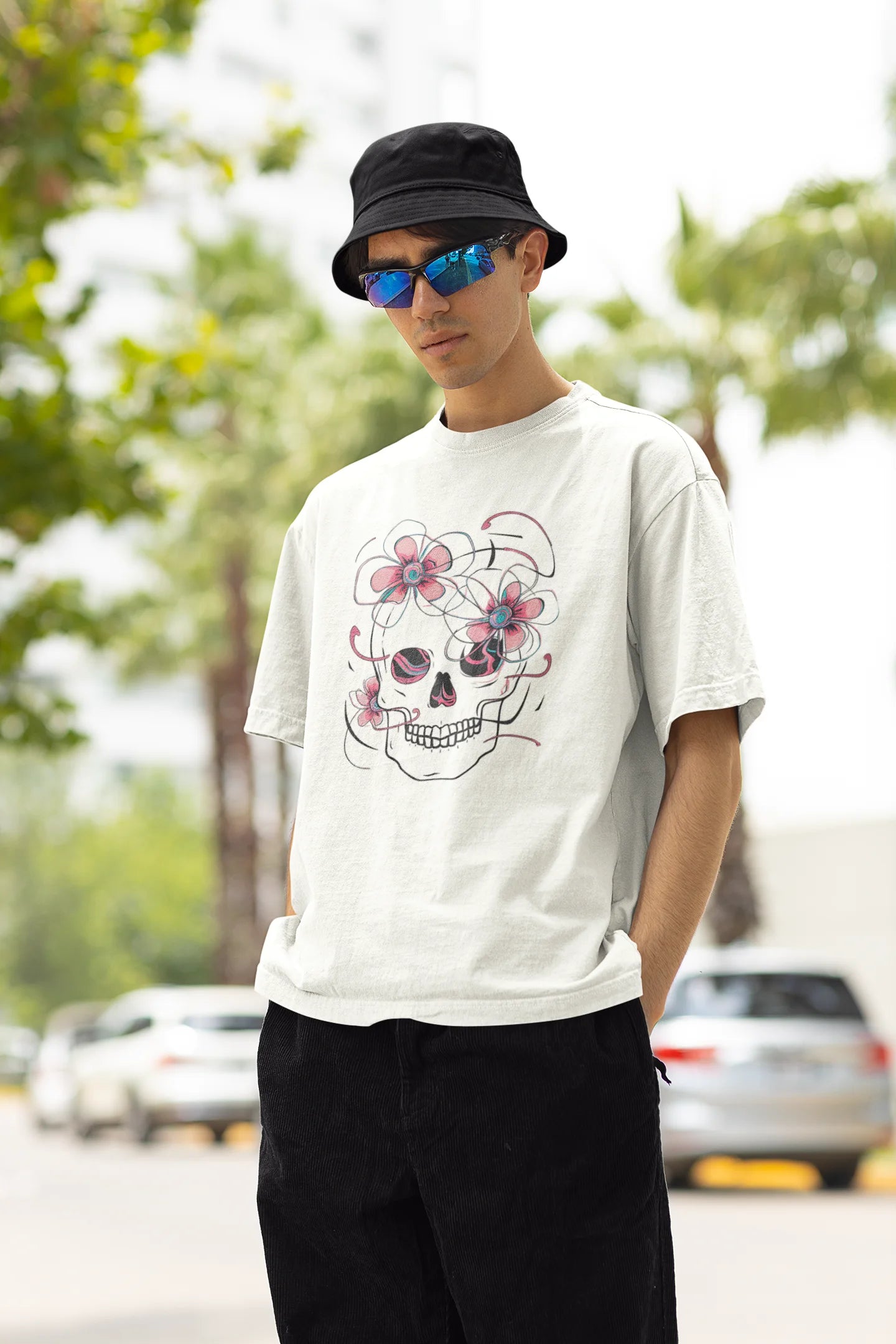 Left side view of male model wearing an off-white oversized t-shirt with a psychedelic skull flower design, perfect for a hippie, trance, or groovy style.