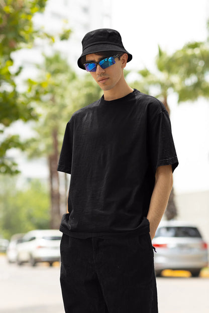 Front view of a male model wearing a black oversized t-shirt with a metal flower design and "Be a Voice, Not an Echo" slogan.
