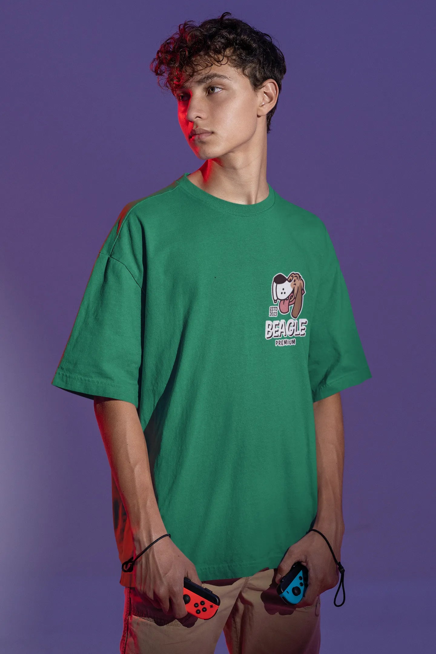 Front view of male Model showcasing forest green oversized tee with a The Beagles animated series themed design, featuring the cool canine quartet from ourt disney collection of oversized tees.