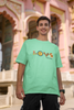 Second front view of a male model wearing an mint green oversized t-shirt with a colorful design that celebrates Marathi culture. Ideal for anyone who loves Maharashtra and its vibrant heritage.