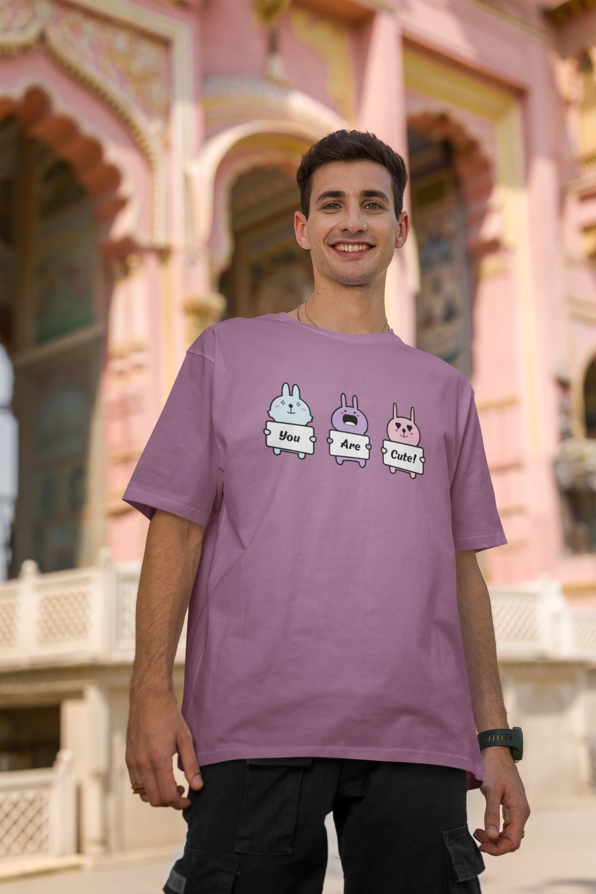 Second image of male model wearing Disney-themed dirty purple oversized tee with a cute cartoon design