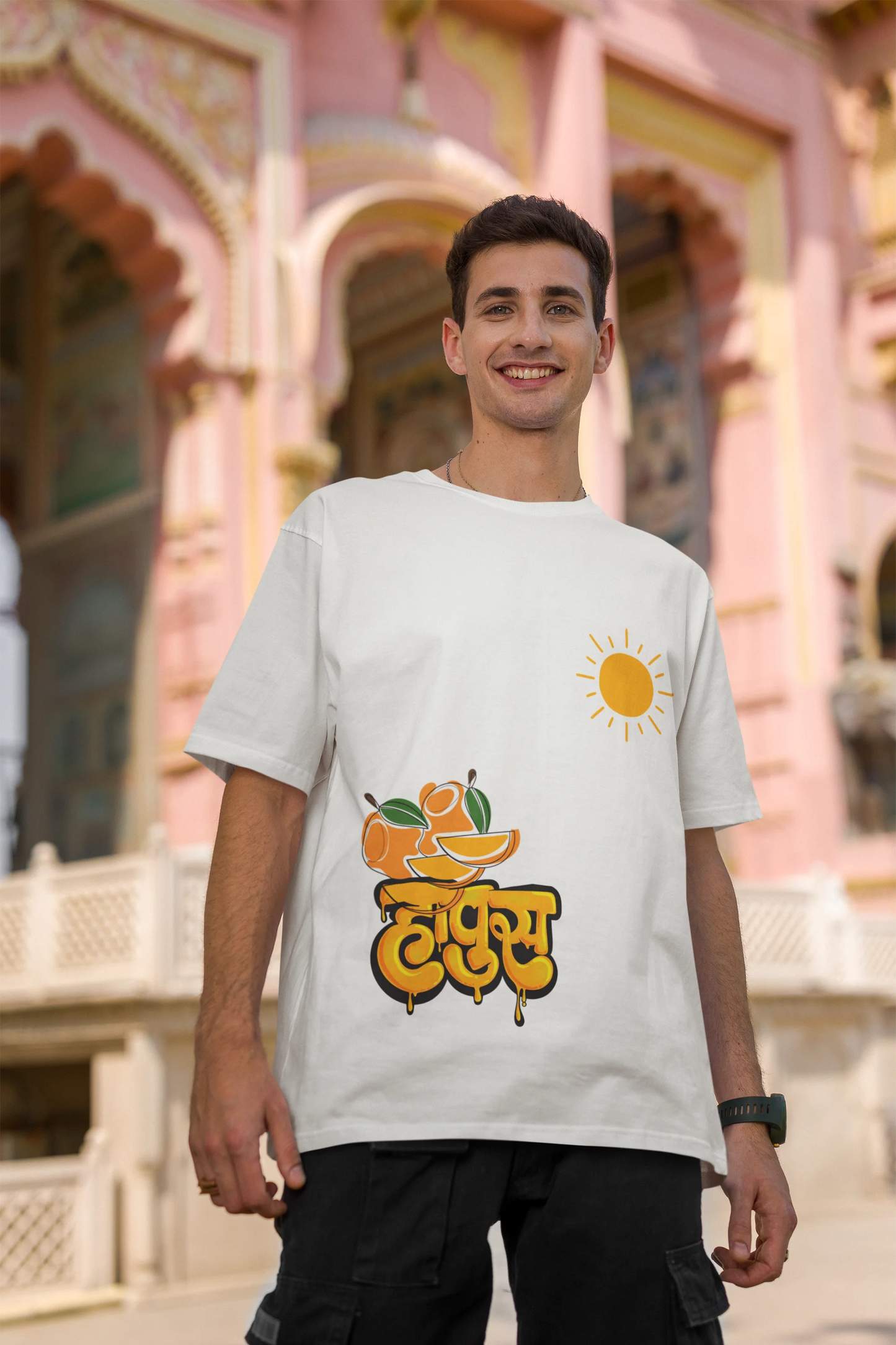Second front view of male model wearing an off-white oversized t-shirt featuring a design inspired by the Marathi word "Hapus," meaning Alphonso mango. Ideal for fans of Marathi culture, foodies, and anyone who loves the king of fruits.