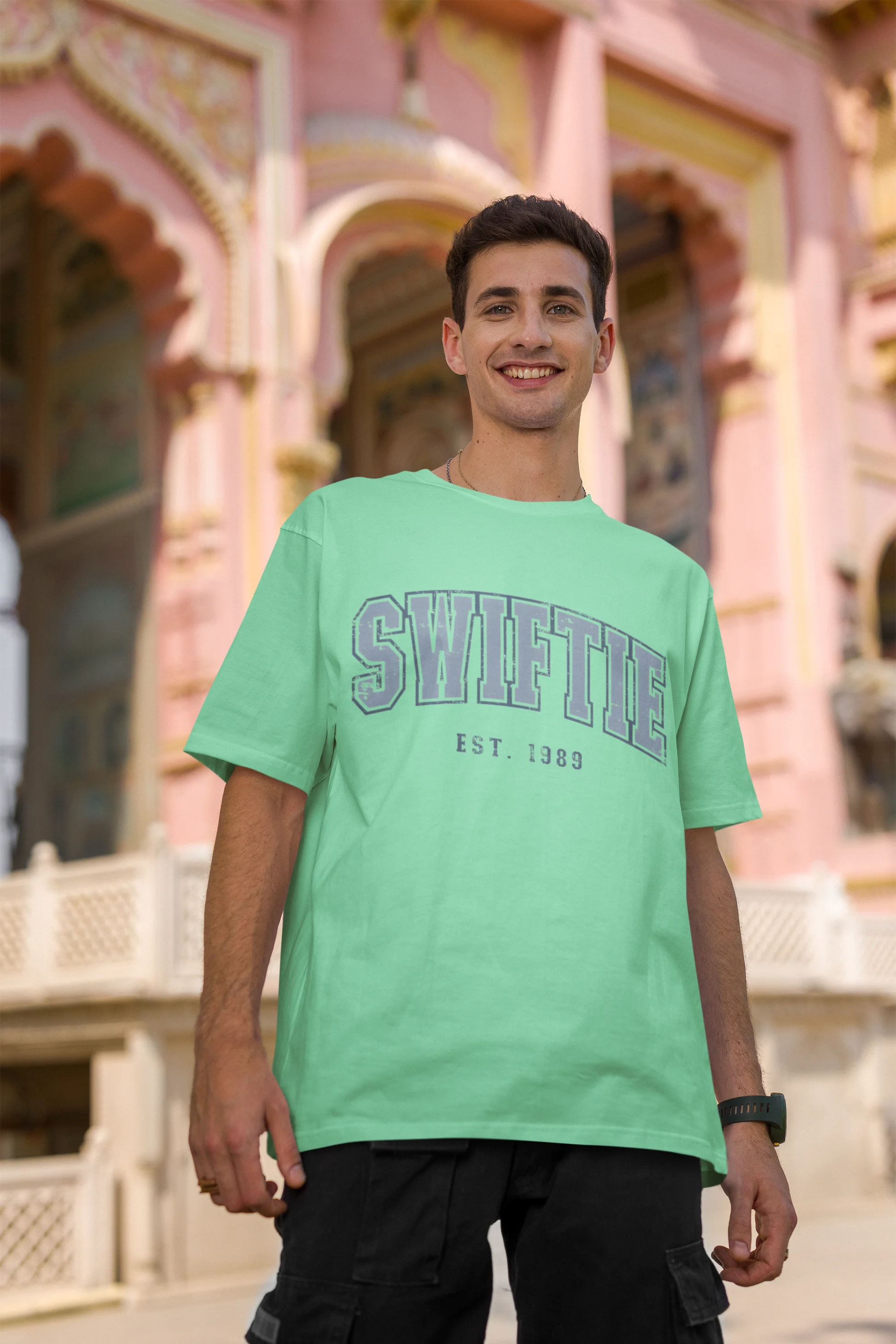 Second image of man wearing mint green Oversize T-shirt featuring Swiftie design, taylor's version