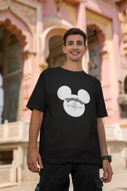 Second image of male model wearing a black oversized Disney collection t-shirt featuring a classic Disneyland design.