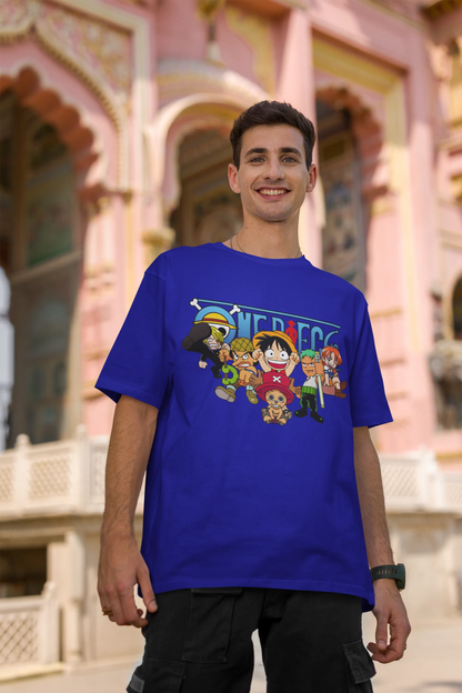 2nd front view of a male model wearing a royal blue oversized t-shirt featuring chibi versions of the Straw Hat Crew from the One Piece anime.
