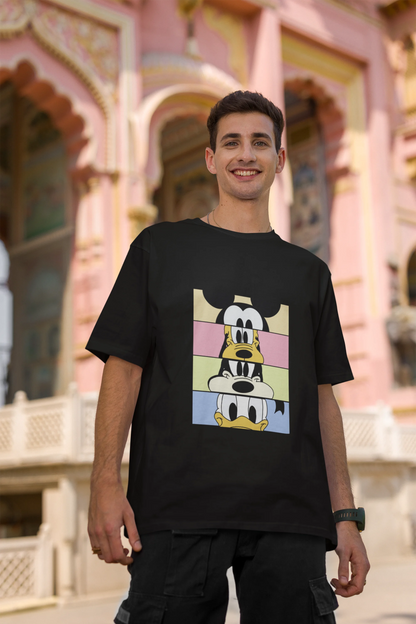 Second image of male Model showcasing black oversized t-shirt inspired by Mickey Mouse Clubhouse characters: Mickey Mouse, Donald Duck, Goofy, and Minnie Mouse