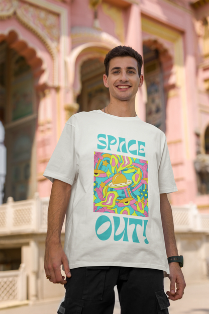 Second image of male model wearing an off white oversized "Spaced Out" t-shirt featuring a vibrant color mashup design that evokes a sense of space exploration, playful aliens, and distant galaxies.