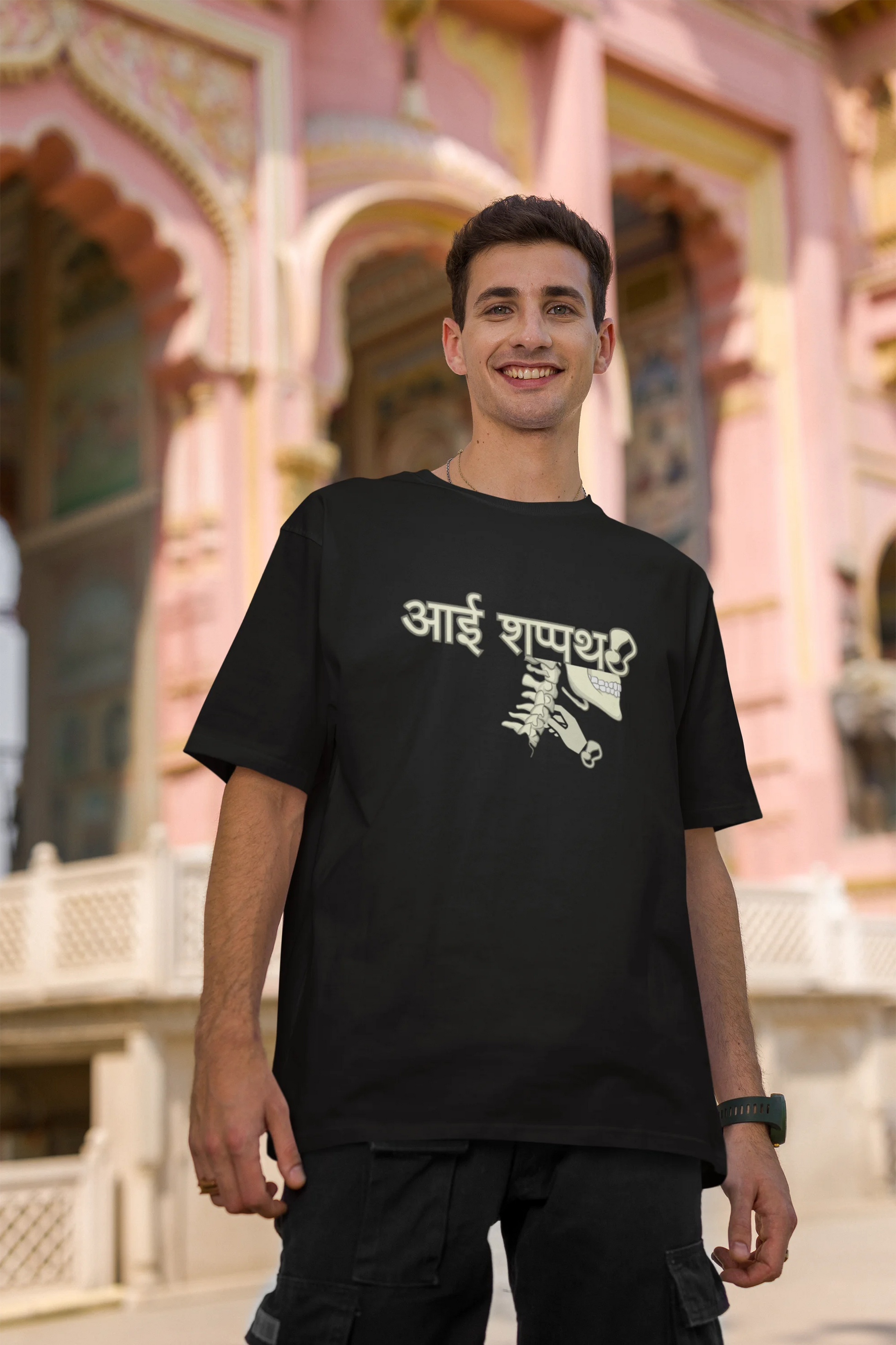 Second front view of male model wearing a black oversized t-shirt featuring a design inspired by the Marathi saying "Aai Sapath." Perfect for fans of Marathi culture and anyone who wants to celebrate their heritage.