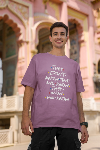 Second image of male model wearing dirty purple oversized t-shirt with F.R.I.E.N.D.S series inspired designs, embodying Phoebe's unique humor with the quote 'They Know We Know'
