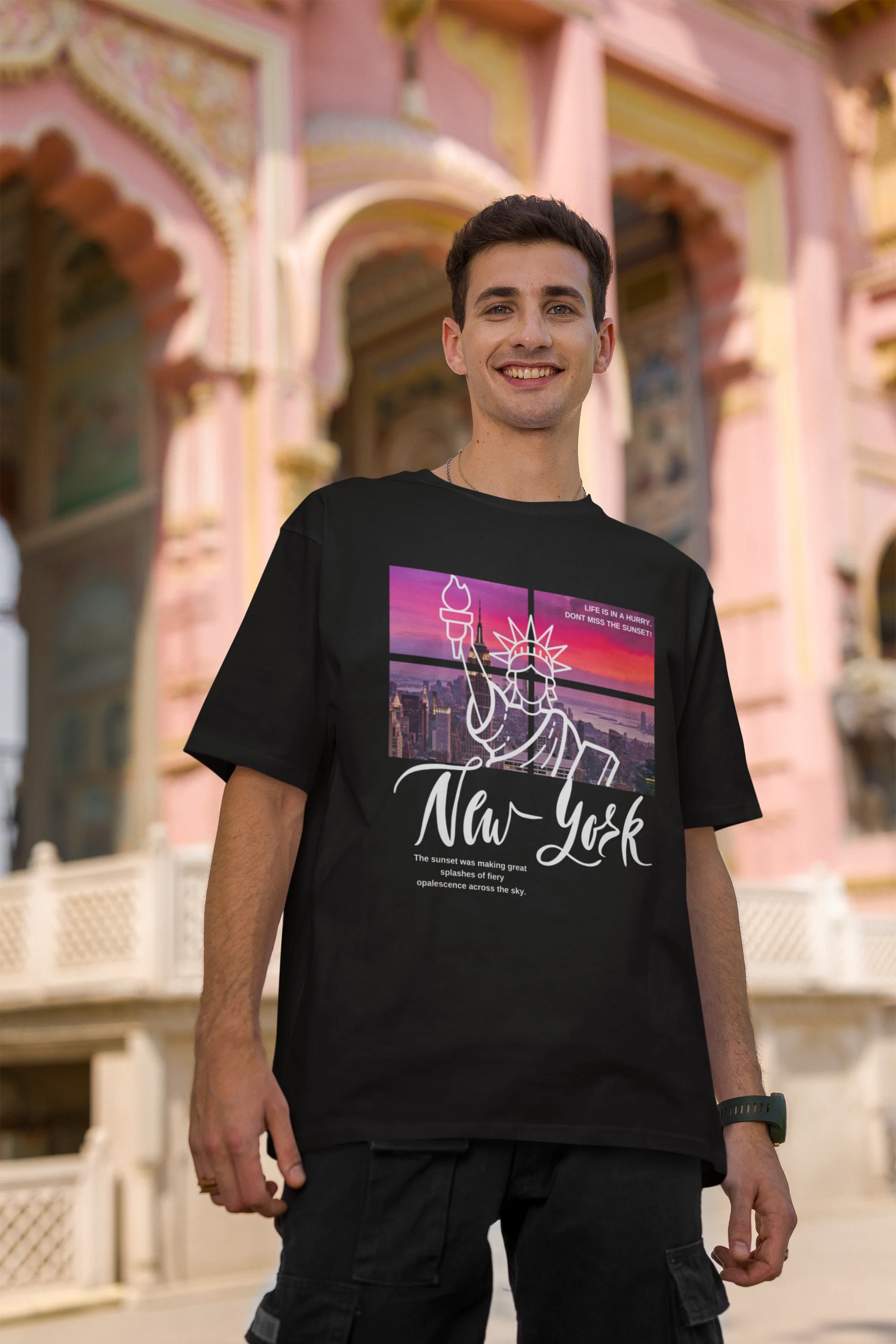 Second front view of a male model wearing a black oversized t-shirt with a New York City skyline design, offering a relaxed urban aesthetic.