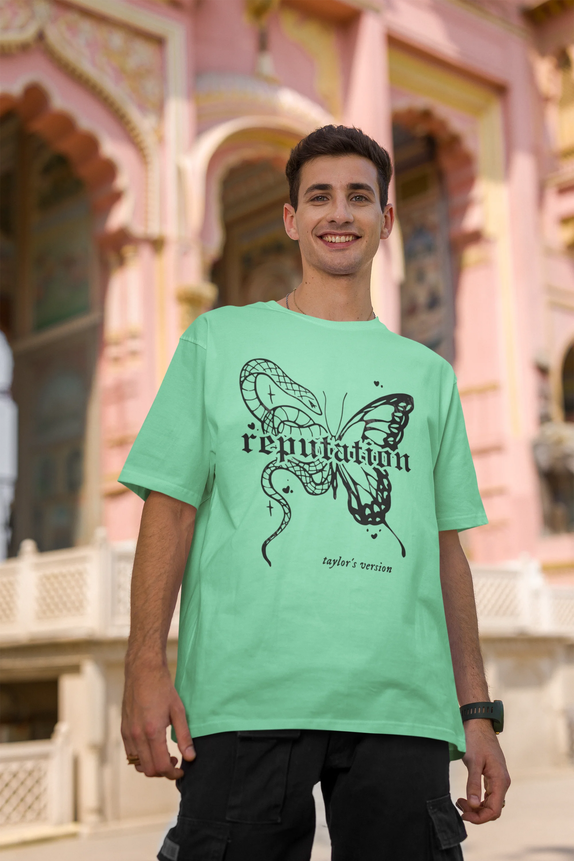 Second Image of a man wearing mint green Oversize t-shirt featuring Reputation Taylor's Version design inspired by Taylor Swift's Reputation era