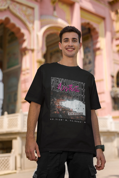 Second front view of a male model wearing a black oversized t-shirt with a New York City skyline design, offering a relaxed urban aesthetic.