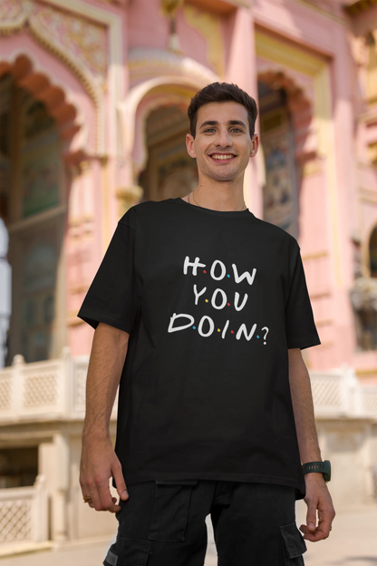 Second image of female model wearing black oversized t-shirt with F.R.I.E.N.D.S series inspired designs, embodying Joey's famous catchphrase 'How You Doin'?