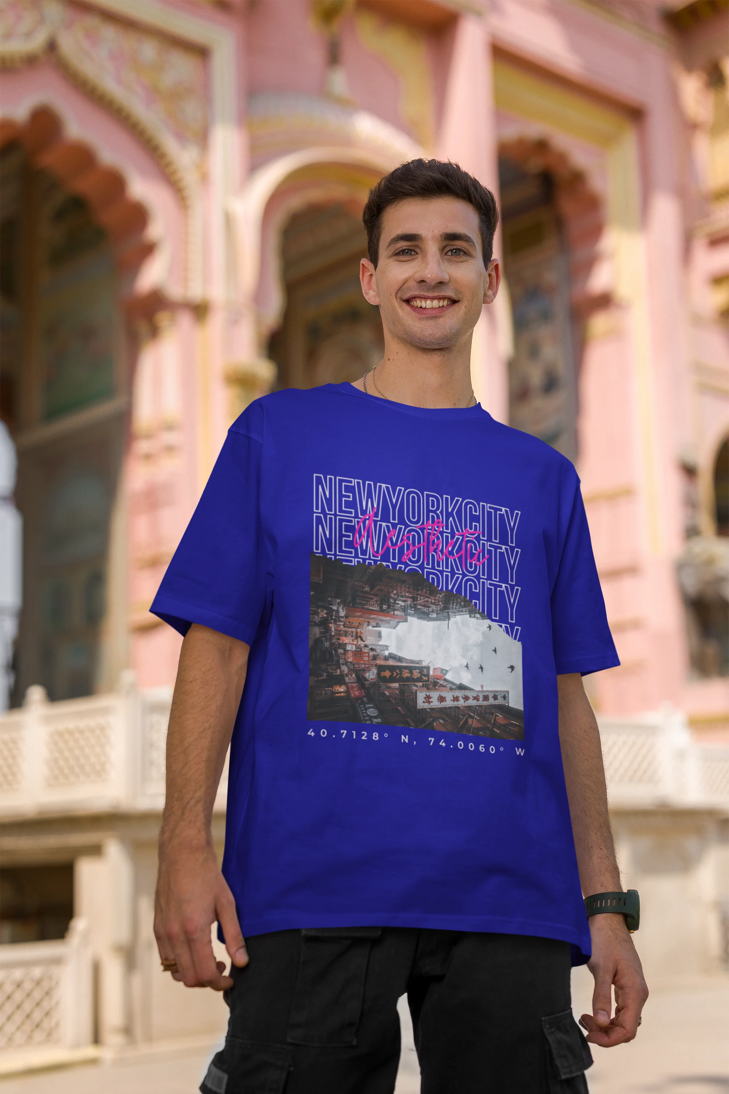 Second front view of a male model wearing a royal blue oversized t-shirt with a New York City skyline design, offering a relaxed urban aesthetic.