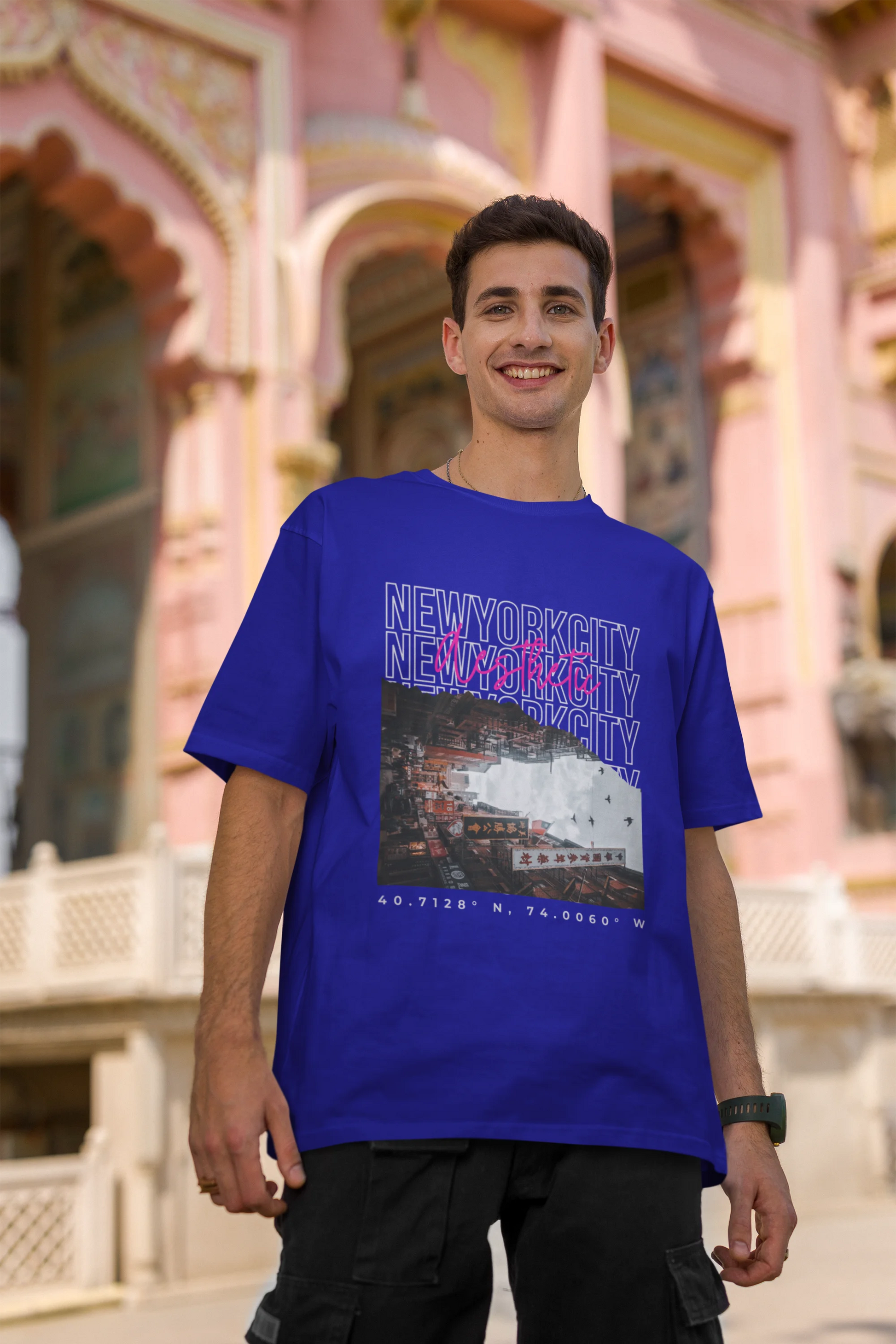 Second front view of a male model wearing a royal blue oversized t-shirt with a New York City skyline design, offering a relaxed urban aesthetic.
