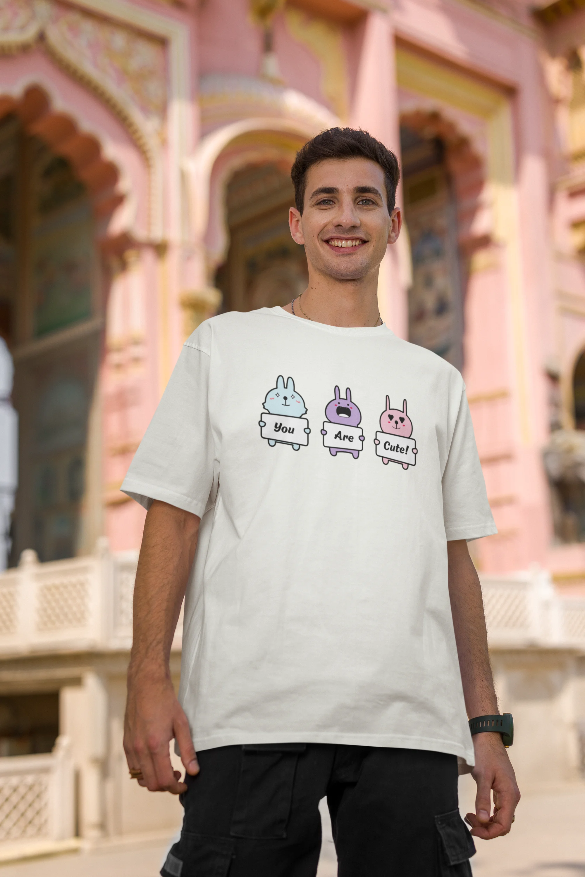 Second image of male model wearing Disney-themed off-white oversized tee with a cute cartoon design