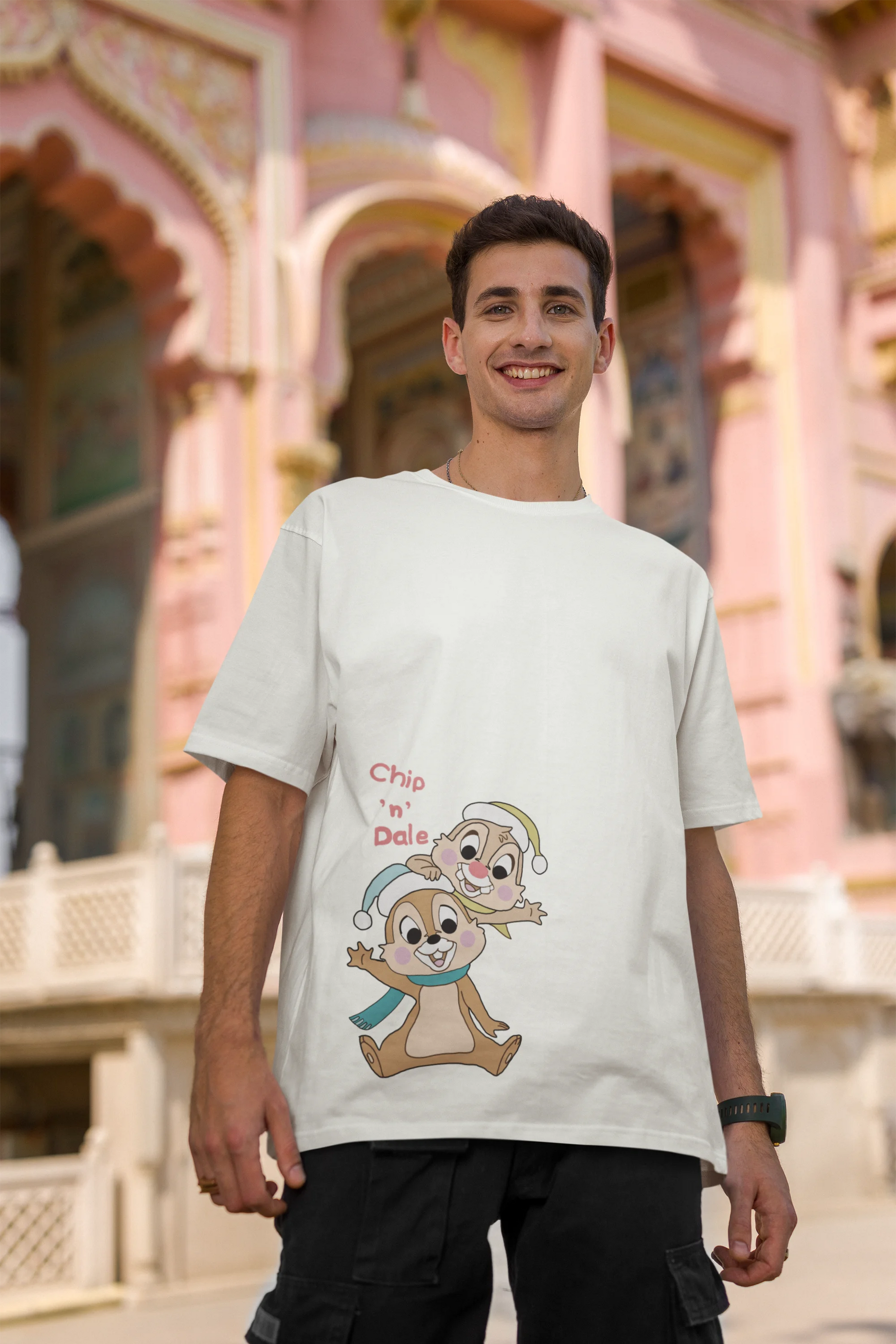 Second image of male model wearing off-white oversized tee with a Disney's Chip and Dale design, featuring the adorable duo in a playful scene.