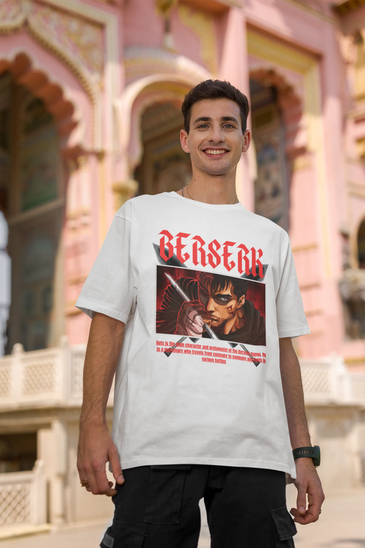 2nd front view of a male model wearing an off-white oversized t-shirt featuring Guts from the Berserk anime with the text "Berserk" across the design.