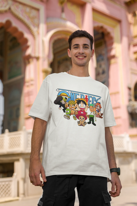 2nd front view of a male model wearing an off-white oversized t-shirt featuring chibi versions of the Straw Hat Crew from the One Piece anime.